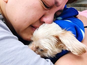 Midsection of man sleeping puppy