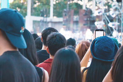 Rear view of people photographing