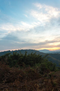 Scenic view of mountains against cloudy sky