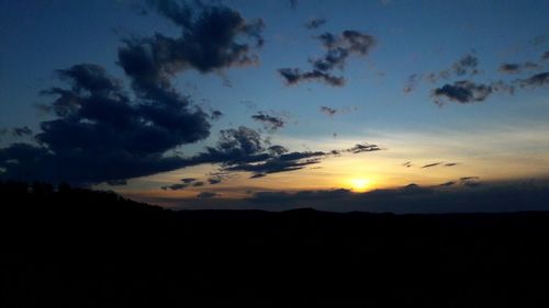 Low angle view of silhouette birds flying against sky during sunset