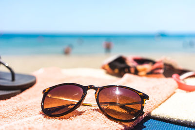 Close-up of sunglasses on beach