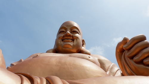 Low angle view of statue against blue sky