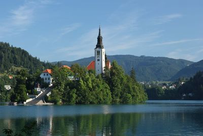 Scenic view of building by mountains against sky