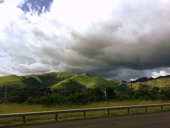 Scenic view of landscape against cloudy sky