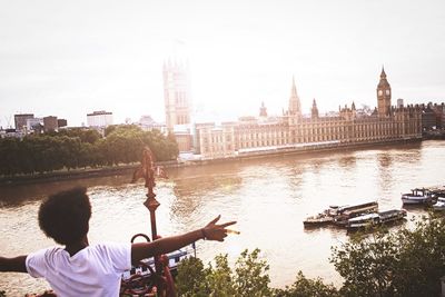 Woman looking at river in city