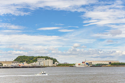 Scenic view of sea against buildings in city