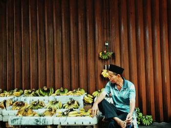 Man sitting on potted plant