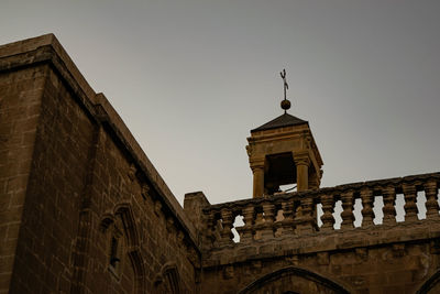 Low angle view of old building against clear sky