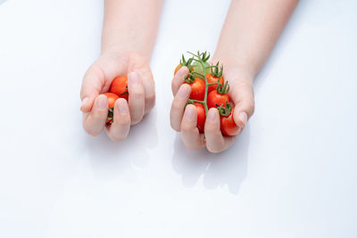 Midsection of man holding ice cream against white background