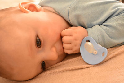 Close-up portrait of baby lying