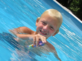 Portrait of boy swimming in pool