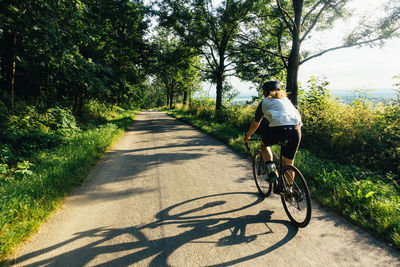 Man riding bicycle on road