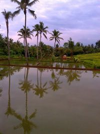 Scenic view of lake against cloudy sky