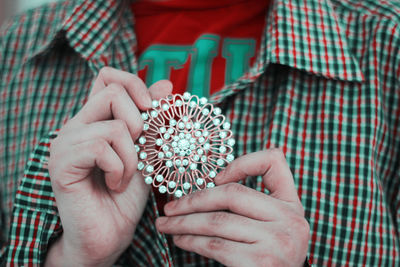 Close-up of hand holding bouquet of people