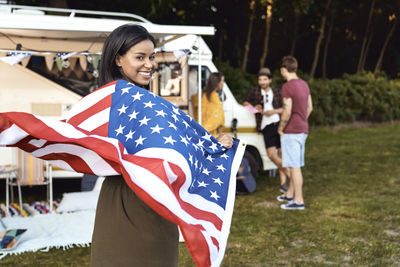 Smiling woman holding american flag