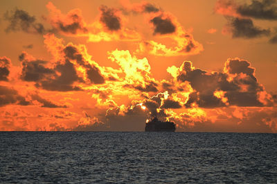 Scenic view of sea against orange sky