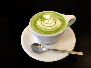 High angle view of cappuccino on black background