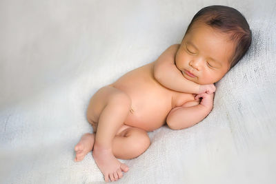 Portrait of cute baby boy lying on floor