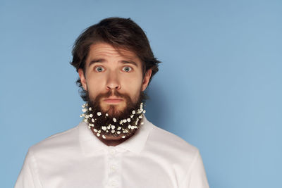 Portrait of young man against blue background