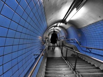 Rear view of people walking on staircase