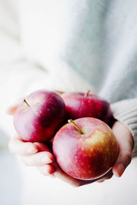 Hands holding apples