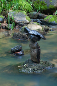 Stones on rock by lake