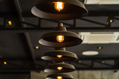 Close-up of illuminated lamp hanging on table in building