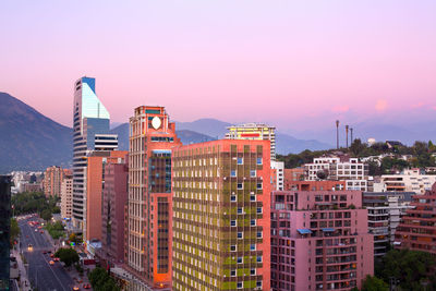 Buildings in city against clear sky