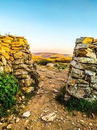 Rock formations on landscape against clear sky