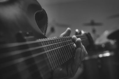 Close-up of hand playing guitar