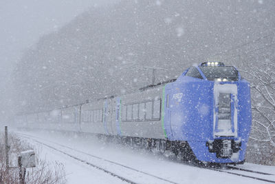 Train on railroad tracks during winter