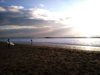 Scenic view of beach against sky during sunset