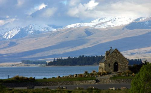 Church of the good shepherd by lake tekapo against snow capped mountains