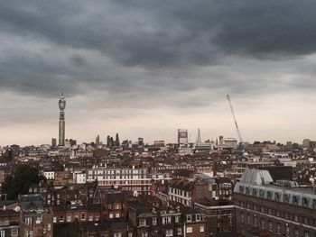 Cityscape against cloudy sky