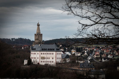 Buildings in town against sky