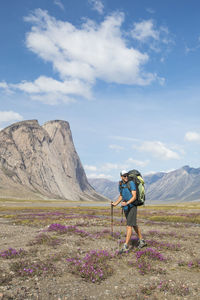 Man standing on mountain against sky