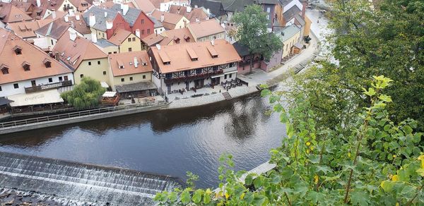 High angle view of canal amidst buildings in town