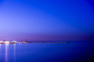 Distant view of bridge over calm sea