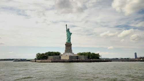 Statue of liberty by bay of water in city