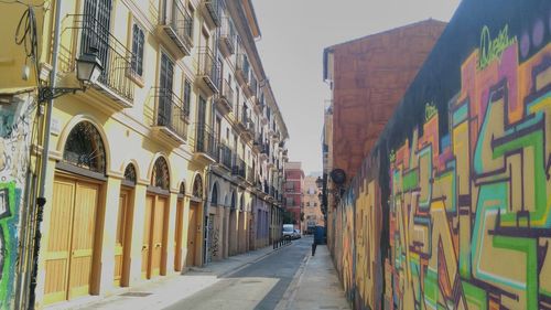 Street amidst buildings in city against sky