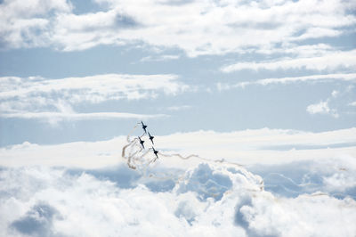 Low angle view of airplane flying against sky