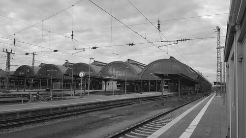 Railroad tracks in city against sky