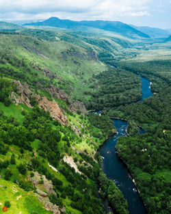 High angle view of river amidst landscape against sky