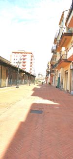 Street amidst buildings against sky