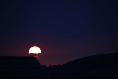 Low angle view of silhouette moon against sky during sunset