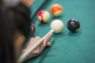 Close-up of woman with balls on table