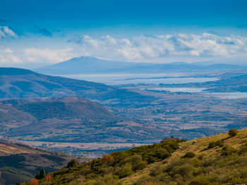 Scenic view of mountains against blue sky