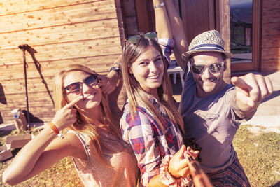 Portrait of smiling friends sitting at home