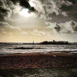 Scenic view of sea against cloudy sky