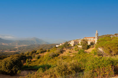 Scenic view of mountains against clear blue sky